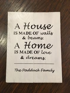 a sign that says a house is made of walls and beams, a home is made of love & dreams