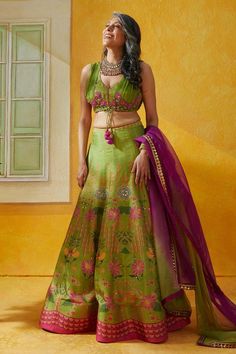 Parrot green tussar lehenga with attached can-can, all over lotus garden print, sequin and bead embellishment. Paired with chiffon leaf neck padded blouse with floral pattern zari, sequin bead work and organza ombre dupatta.
Components:3
Pattern:Printed and Embellished
Type of Work:Lotus Garden Print, Zari, Sequin and Bead Work
Neckline:Leaf Neck
Sleeve Type:Sleeveless
Fabric:Lehenga: Tussar, Blouse: Chiffon, Dupatta: Organza
Color:Green
Other Details:
Embellished border and butti work on dupatt Green Silk Lehenga With Pallu, Green Silk Lehenga With Pallu Detail, Green Lehenga With Pallu In Silk, Green Anarkali Silk Choli, Green Silk Sets For Reception, Green Silk Semi-stitched Lehenga, Fitted Green Raw Silk Lehenga, Festive Green Silk Lehenga, Green Silk Choli For Wedding