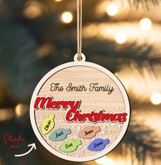 a christmas ornament hanging from a tree with the words merry christmas written on it