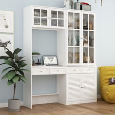 a white bookcase with glass doors and drawers in the corner of a living room