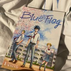 a blue flag book laying on top of a bed