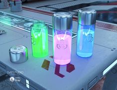 three water bottles sitting on top of a table next to canisters and cans