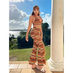 a woman standing on top of a patio next to a pillar