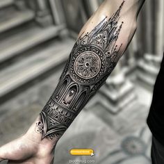 a man's arm with a clock on it and an intricate design in the middle