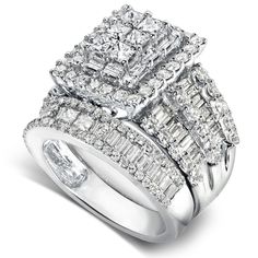 three stone diamond ring set in 18k white gold with baguetts and diamonds