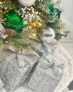 a christmas tree decorated with silver and green ornaments