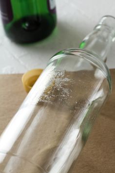 an empty glass bottle sitting on top of a table