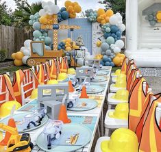 an outdoor party with construction themed tables and decorations