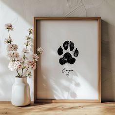 an animal paw print with the word crayo on it next to a vase filled with flowers