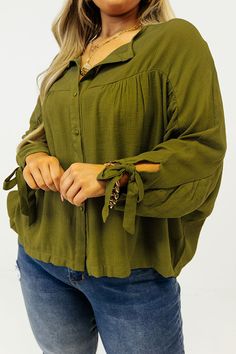 You and this darling plus size green shift top were made for each other with its lightweight material, a button up front with a rounded neckline, long loose sleeves with tie closure cuffs, and a relaxed silhouette that falls into a straight hemline! Measurements 1XL : Bust 62", Hip 56", Length 25", Sleeve Length 23", Waist 60". 2XL : Bust 64", Hip 58", Length 25.5", Sleeve Length 23", Waist 62". 3XL : Bust 66", Hip 60", Length 26", Sleeve Length 24", Waist 64". Green Blouse With Tie Sleeves For Spring, Green Tie Sleeves Blouse For Spring, Spring Green Blouse With Tie Sleeves, Olive Long Sleeve Blouse For Spring, Green Stretch Tops With Button Closure, Olive Long Sleeve Blouse For Fall, Green Button-up Blouse For Fall, Green Blouse With Roll-up Sleeves For Spring, Casual Olive Long Sleeve Blouse