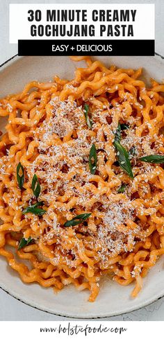 a white plate topped with pasta covered in cheese