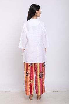 Off-white pure linen shirt with embroidered multicolor elephant motifs.
Component: 1
Pattern: Embroidered
Type Of Work: Elephant Motifs
Neckline: Mandarin Collar
Sleeve Type: Long Sleeves
Fabric: Pure Linen
Color: White
Other Details: 
Embroidered motifs
Front button placket
Note: Pant worn by the model is not for sale
Occasion: Work - Aza Fashions White Linen Short Sleeve Sets, White Bohemian Short Sleeve Sets, Traditional White Linen Blouse, White Tops With Printed Motifs, White Relaxed Fit Tops With Chikankari Embroidery, Traditional White Linen Sets, Casual White Linen Kurta, White Straight Kurta Tops With Printed Motifs, Traditional Linen Tops With Chikankari Embroidery