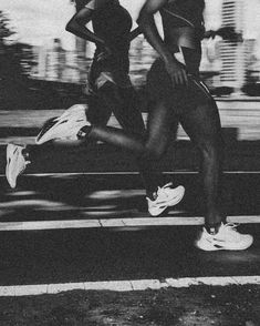 black and white photograph of two women running