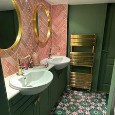 a bathroom with two sinks and a towel rack on the wall in front of it