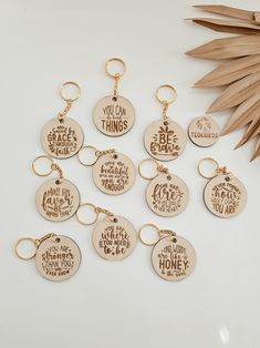 six wooden keychains with different sayings on them