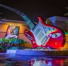 a giant guitar sculpture in front of a building