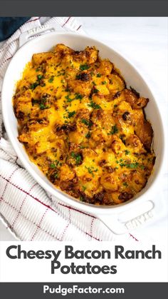 cheesy bacon ranch potatoes in a white casserole dish on a red and white towel