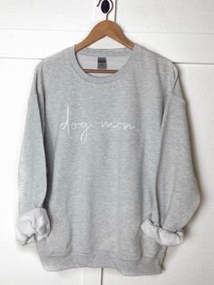 the softest sweatshirt you'll ever own. trust us, you're never going to want to take these off! you can choose between gray or white and the writing can either be black or white. if you would like red writing, just leave it in the notes at checkout. :) size guide: small - full body length 26" - body width 20" medium - full body length 27" - body width 22" large - full body length 28" - body width 24" x-large - full body length 29" - body width 26" care instructions: wash inside out and let air d Dog Mom Sweatshirt, Womens Sweatshirts, Mom Sweatshirt, Vinyl Lettering, Mom Outfits, Large White, Favorite Things Gift, Dog Mom, Full Body