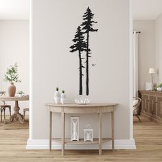 a living room with a table and wall decal in the shape of pine trees