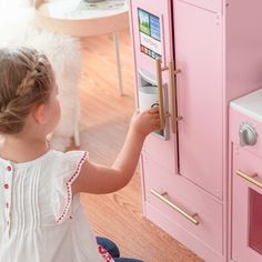 The Little Chef Charlotte Play Kitchen is a chic, interactive wooden modular play kitchen that is the perfect addition to playtime. Interactive, with a built-in icemaker and oven knobs that click and turn realistically, the extended countertop provides plenty of space for food prep and imaginative play. This play kitchen comes in two pieces and in a colorfur finish with sleek gold hardware. Includes four storage compartments making it easy to keep toys organized when playtime is over. Teamson Ki Play Kitchen Food, Low Cupboard, Wooden Toy Kitchen, Kids Play Table, Play Kitchen Sets, Kitchen Refrigerator, Pink Kitchen