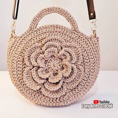 a crocheted purse with a flower on the front