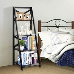 a book shelf next to a bed with white sheets and pillows on top of it