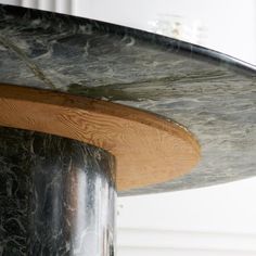 a close up view of a table with marbled top and wood trim around the edge