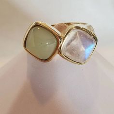 Are you looking for the perfect everyday ring? This style has it all, the beautiful rainbow colors of the moonstone--the soft, calming blue green color of the Chalcedony. The combination of the two is ideal--the smooth-contoured surface of the ring blends with the calming vibe of the design. The cushion-shaped pointed cabochon gemstones are 8.8 mm each--size 8.25, sizeable. This 10 karat yellow gold ring is 12.5 mm at it's the widest point and 3.4 mm at the bottom.  Overview: Size 8 1/4 sizable ✳️ 8.8mm moonstone 8.8mm teal Chalcedon 10-karat yellow gold 7.08 grams This piece is part of our designer collection, featuring more contemporary or modern designs curated in collaboration with our partner Culet Jewelry. These one-of-a-kind designs boast the same quality and craftsmanship that you Amethyst Necklace Vintage, Blue Green Color, Buckle Ring, Everyday Ring, Everyday Rings, Amethyst Necklace, Diamond Cluster Ring, Beautiful Rainbow, Yellow Gold Ring