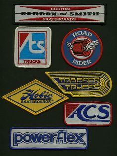 several different types of stickers on a black surface