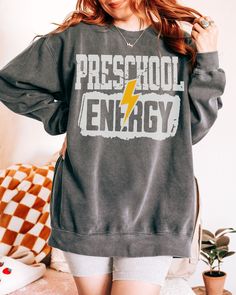 Preschool Teacher Sweatshirt Preschool Energy teacher gift halloween Christmas appreciation funny new custom classroom hoodie comfort colors >> A premium soft blend UNISEX sweater: ** 50% cotton, 50% polyester ** Pre-shrunk ** Classic fit with no center crease ** 1x1 athletic rib knit collar with spandex ** Air-jet spun yarn with a soft feel and reduced pilling ** Double-needle stitched collar, shoulders, armholes, cuffs, and hem ** Rolled sleeves in pictures is for styling purposes only CARE IN Sweater Over Dress, Sweater Outfits Men, Teacher Wear, Third Grade Teacher, Sweater Dress Outfit, Second Grade Teacher, Teacher Sweatshirt, First Grade Teachers, Funny New