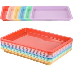 a stack of plastic trays with different colors on each side and one empty tray in the middle