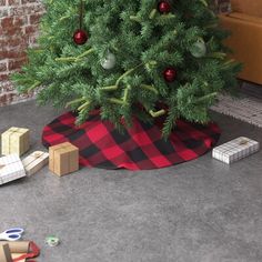 a small christmas tree with presents under it