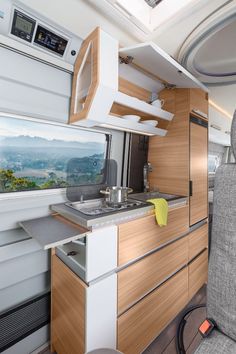 the interior of an rv with wood cabinets