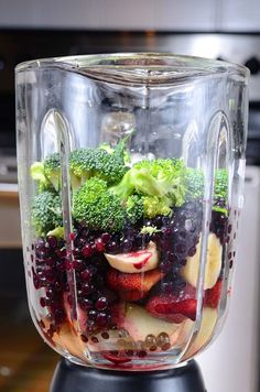 a blender filled with fruit and vegetables on top of a counter