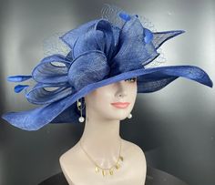 "The oversized brim adorned with a jumbo sinamay bow in and feathers  design characterizes this horse racing event hat made of natural straw. The large brim creates a statement piece, and the sinamay jumbo bow  and netting adds a touch of whimsy and feminine elegance. Crafted from straw, it exudes a light and airy feel, making it a stylish and comfortable choice for a day at the races. The hat combines the classic appeal of a wide brim with the playful charm of a jumbo sinamay bow and netting , Feathered Top Hat For Kentucky Derby Races, Feather Trim Costume Hats For Kentucky Derby Races, Feathered Hat For Royal Ascot Races, Kentucky Derby Costume Hats With Feather Trim, Wide Brim Feather Trim Fascinator For Races, Wide Brim Fascinator With Feather Trim For Races, Royal Ascot Hats With Feather Trim, Wide Brim Feather Trim Fascinator For Kentucky Derby, Kentucky Derby Wide Brim Fascinator With Feather Trim