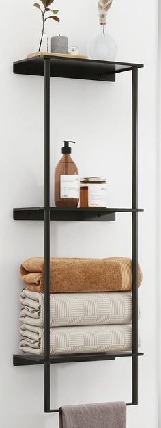 a shelf with towels and soaps on it