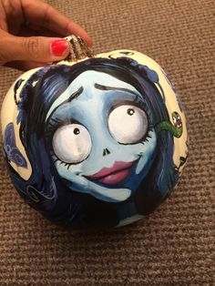 a hand painted ornament with a woman's face on it