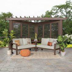 an outdoor seating area with two couches and a table