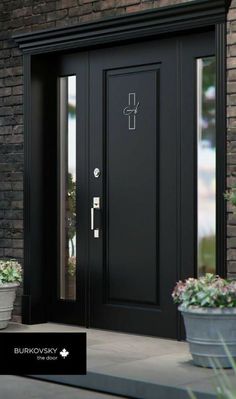 a black front door with two potted plants