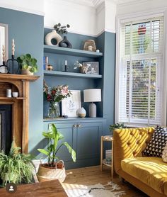 a living room filled with furniture and a fire place under a window next to a fireplace