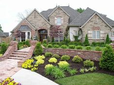 a large brick house with landscaping around it