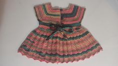 This dress is made from yarn by knitting with needles by hand. Cute Multicolor Winter Dresses, Handmade Fitted Pink Dress, Cute Pink Knitted Dress, Cute Fitted Knit Dress, Multicolor Knit Dresses For Winter, Cute Handmade Pink Dress, Hand Knitted Cotton Dresses In Cute Style, Cute Hand Knitted Cotton Dresses, Hand Knitted Cute Cotton Dresses