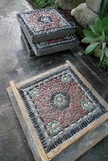 two cement benches sitting next to each other in front of a potted plant on the ground