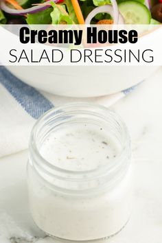 a white bowl filled with salad dressing on top of a table