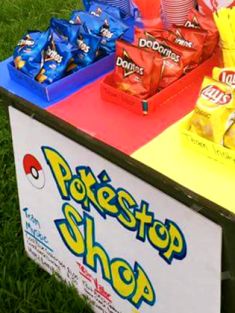 a table that has some food on top of it in front of the sign for pokestop shop