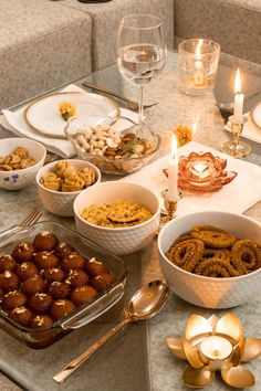 a table topped with lots of food next to a glass of wine and silverware