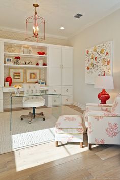 a living room filled with furniture and a glass top desk in front of a white bookcase