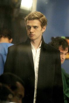 a man in a black jacket and white shirt