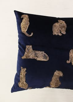 a blue pillow with gold sequins on it and an elephant, giraffe, zebra, tiger