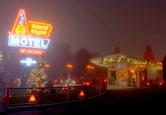 a motel sign lit up with christmas lights